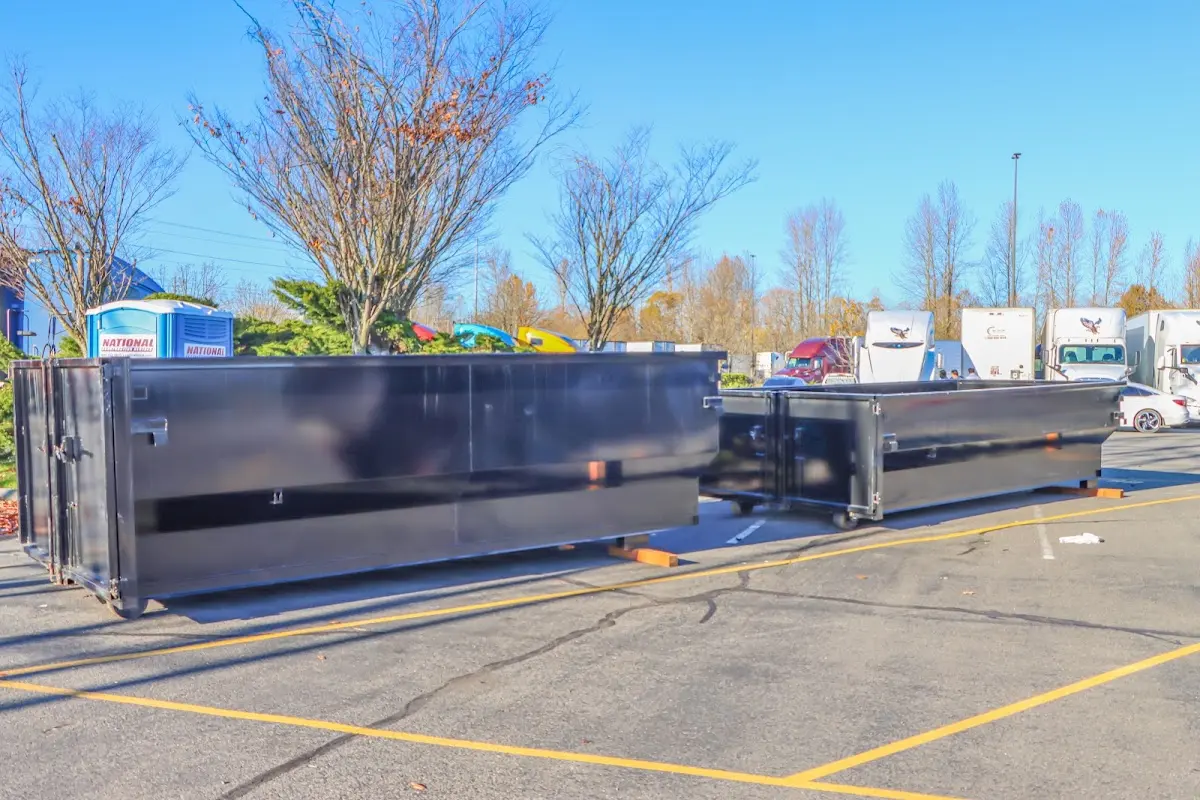 Professional dumpster rental service with roll-off container on residential driveway in Sky Lake